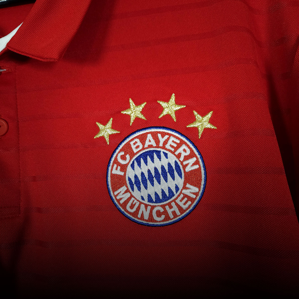 Close-up of a Bayern Munich home football shirt in blue and red colours