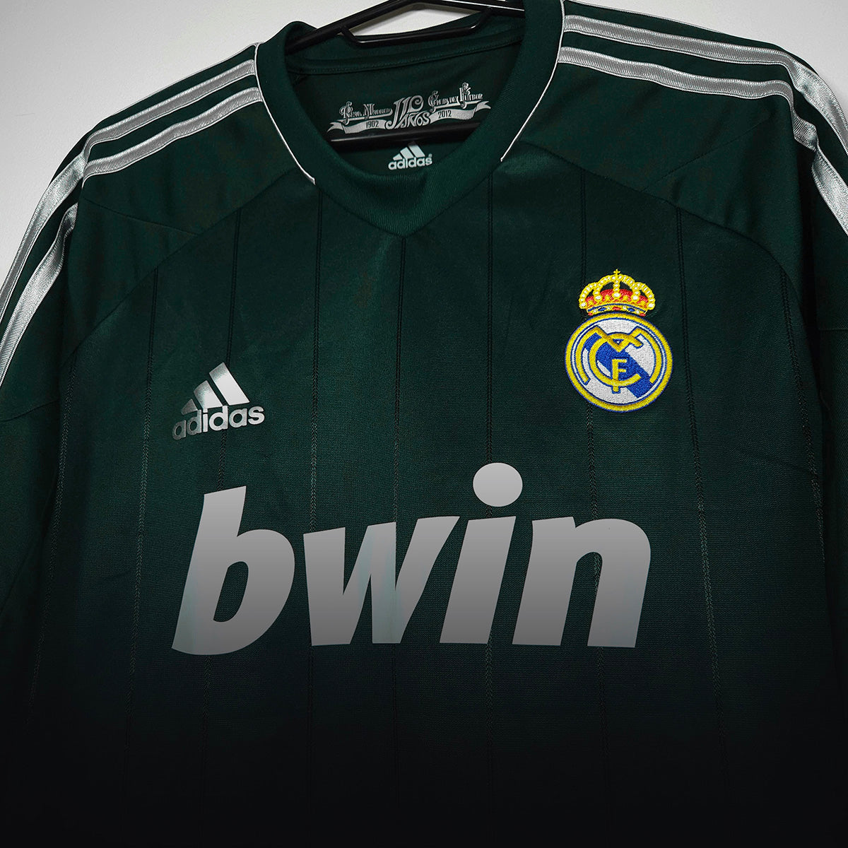 Close-up of a green Real Madrid football shirt with bwin sponsor